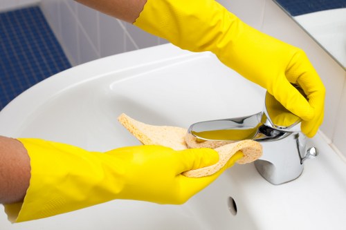 Cleaner wiping high-touch surfaces in a shared corridor